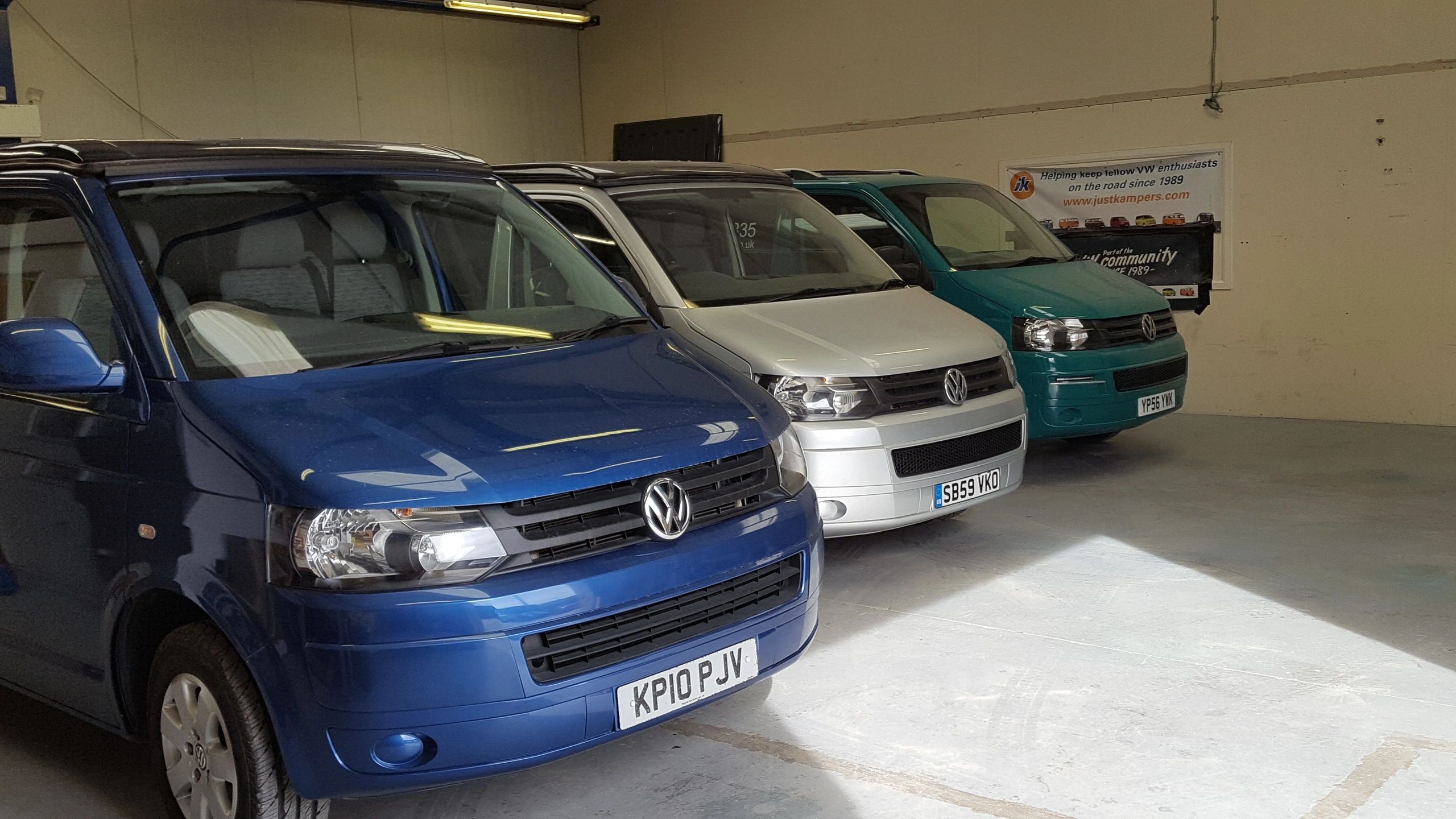A row of Volkswagen campervans in Steve’s Hope Valley workshop