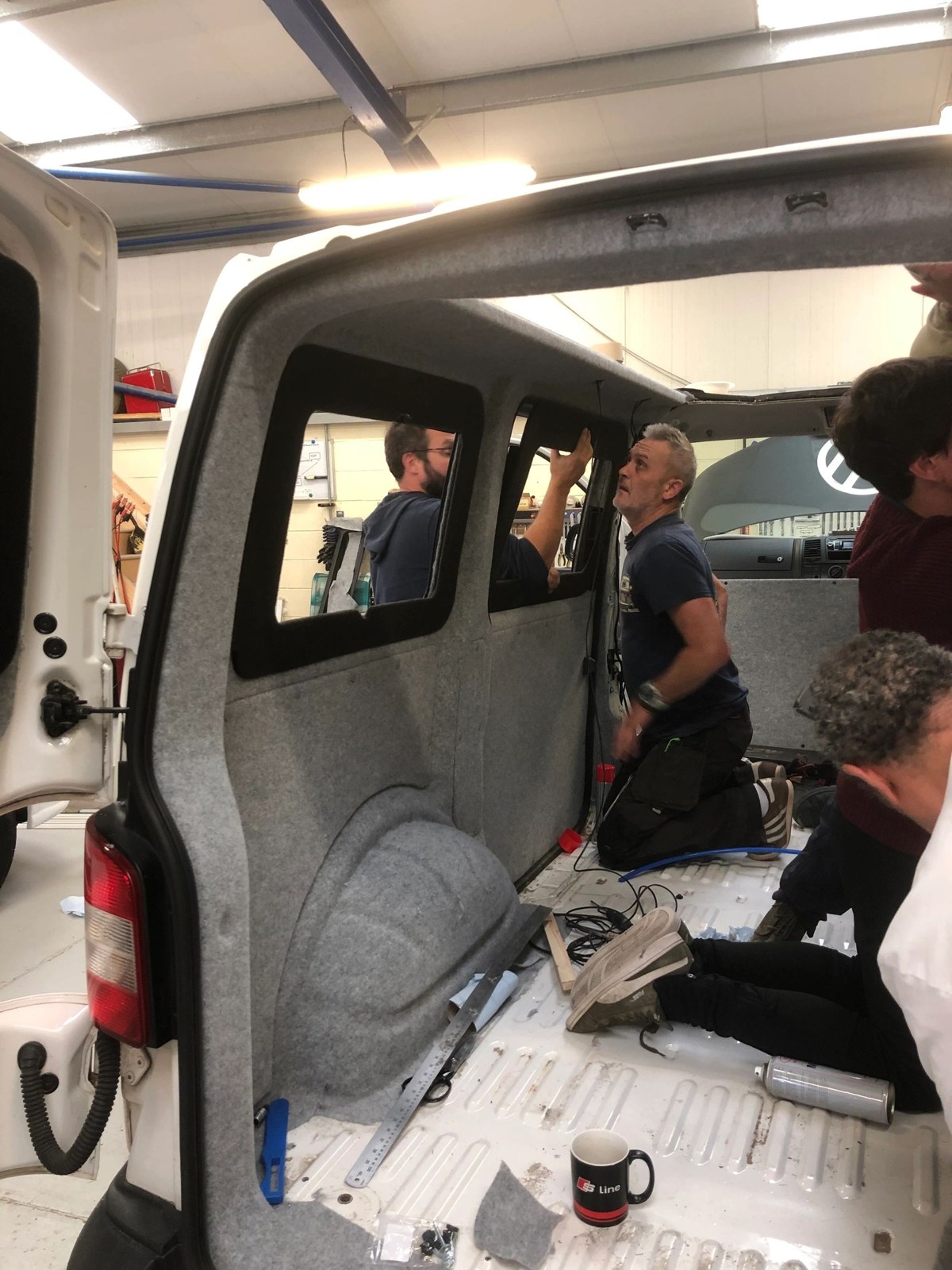 Course participants working inside a campervan