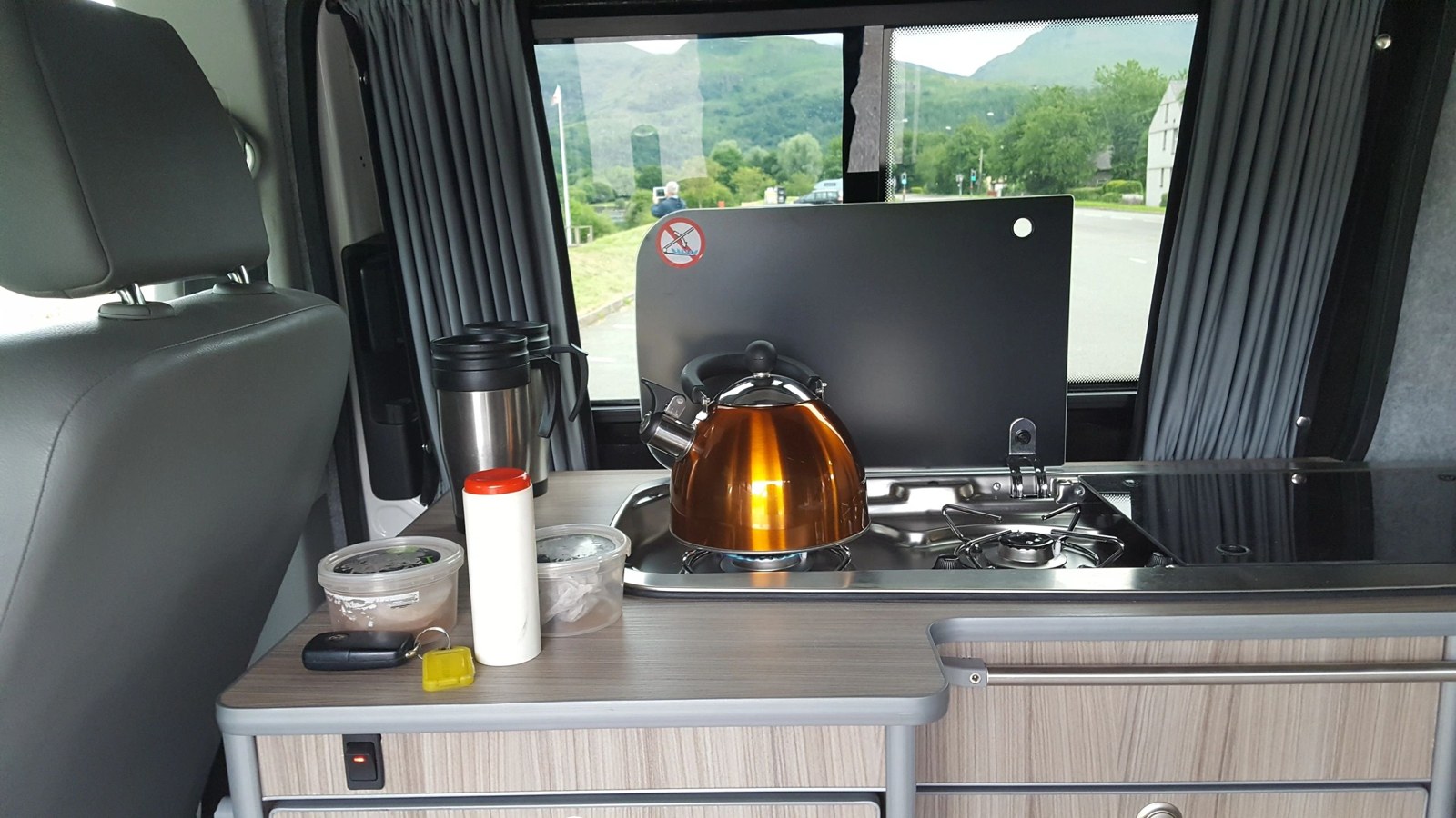 Campervan kitchen with hob, sink and kettle
