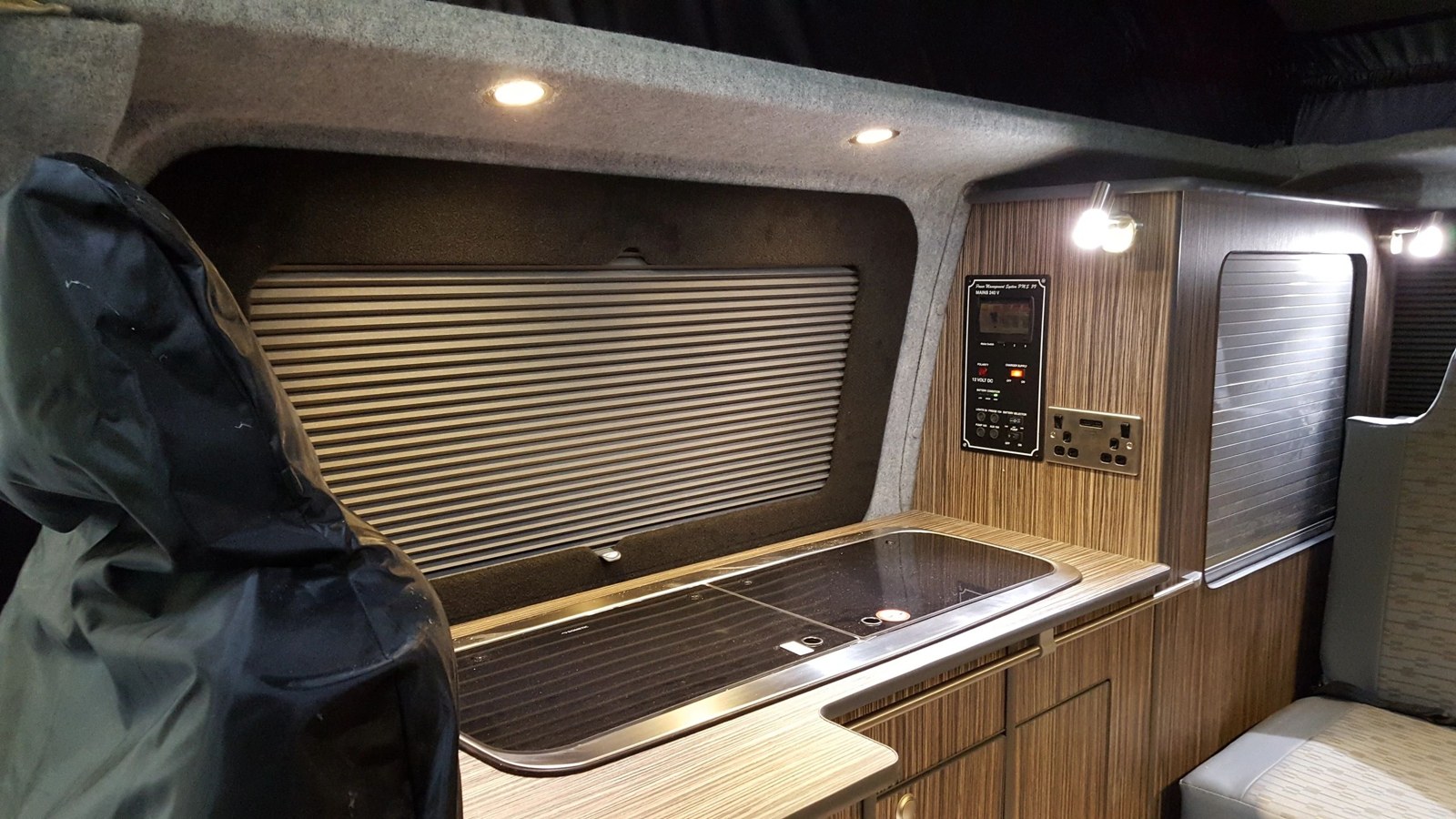 Finished wood-effect campervan kitchen and window blind