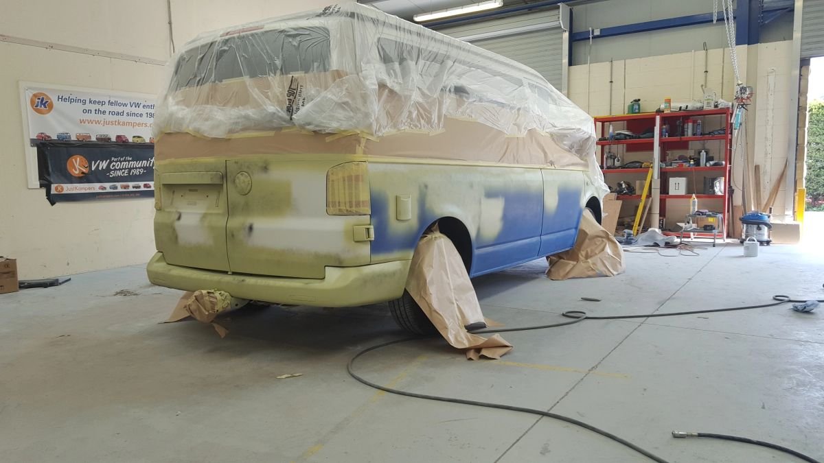 A Volkswagen van masked with paper before paintwork