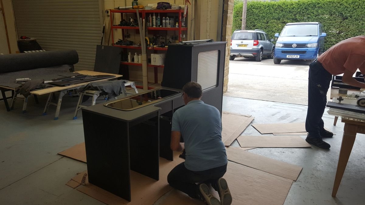 Workshop participants assembling campervan cabinetry