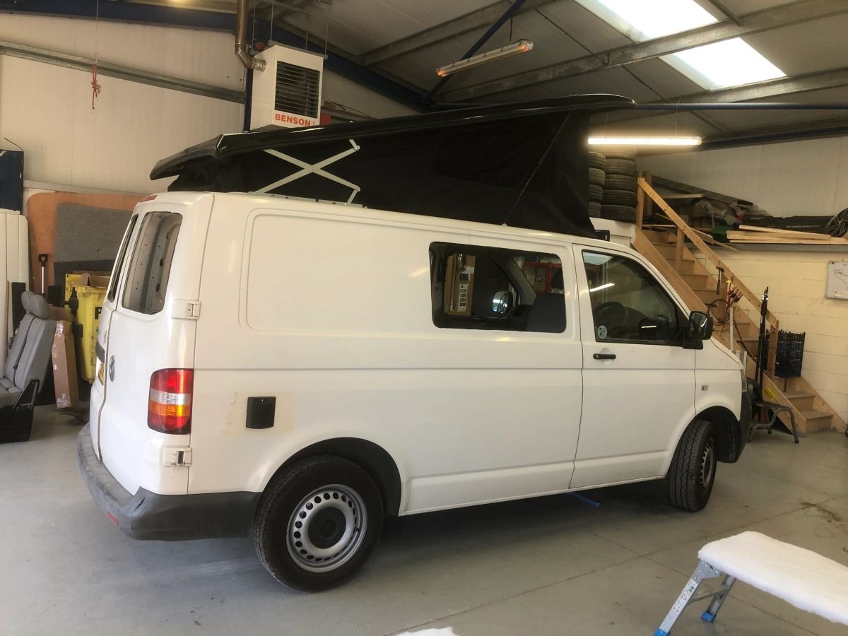 A white van in the workshop during roof conversion