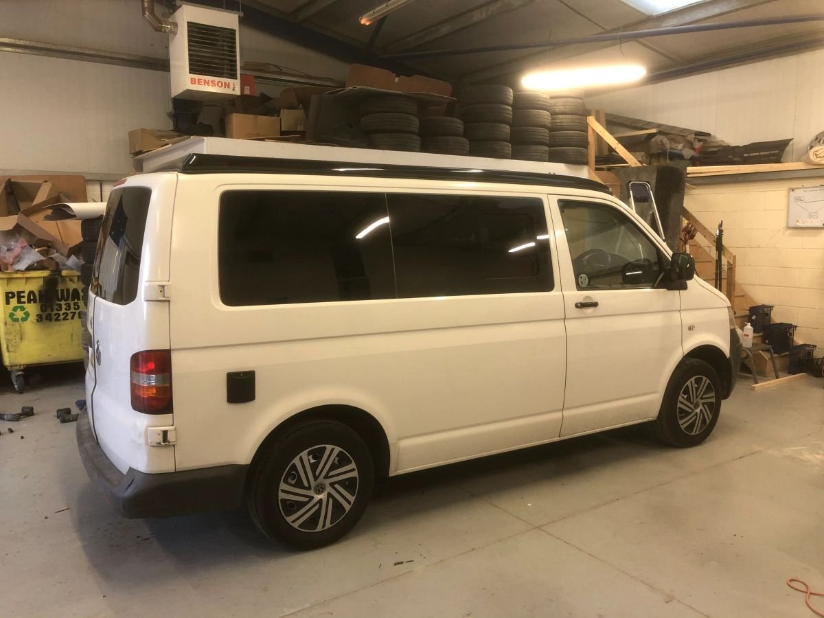 A white Volkswagen campervan during its conversion