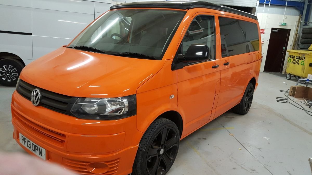 A completed orange Volkswagen campervan