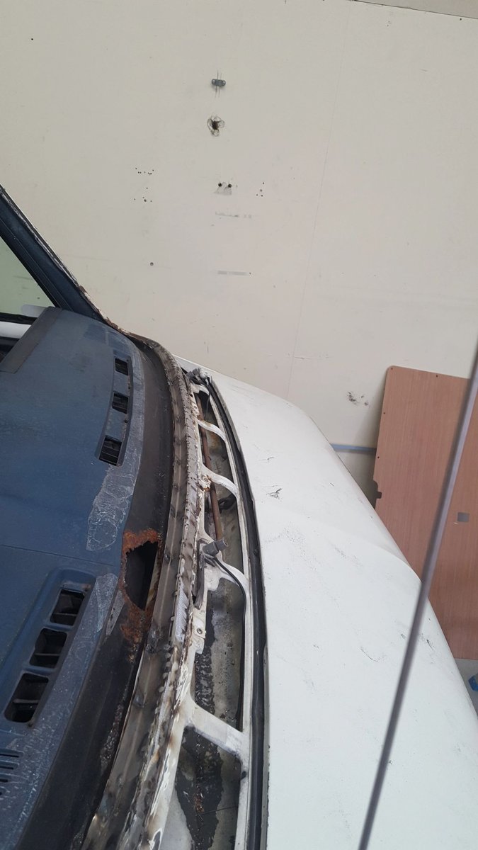 Exposed corrosion along a van body seam during renovation