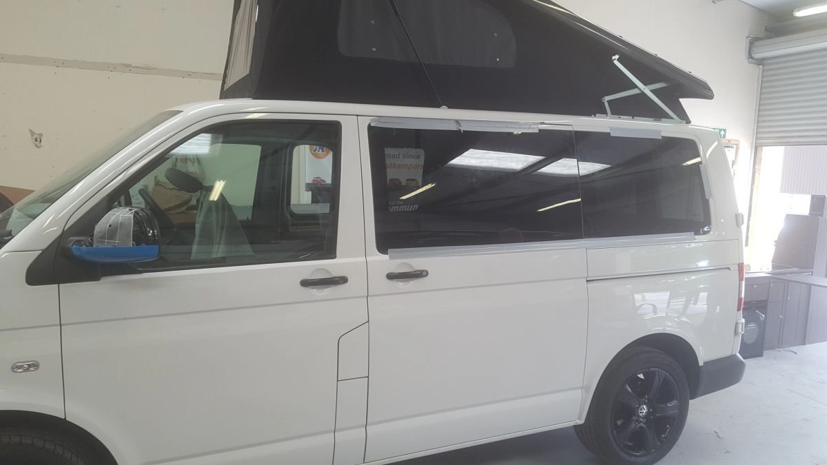A white Volkswagen van undergoing roof conversion